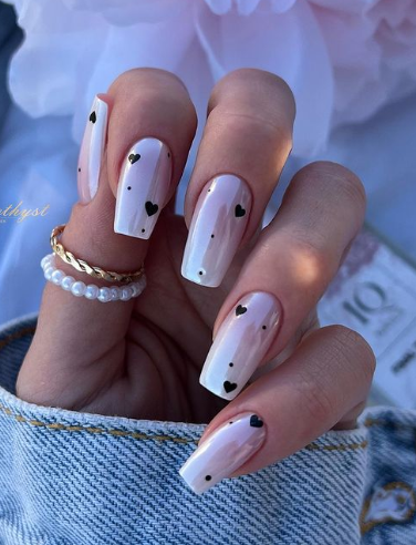 pink glazed donut nails with black hearts. coffin acrylic valentines nails. february nails. loved nails.