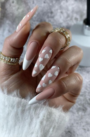 pink matte nude nails with white hearts. heart nails. valentines nails designs. february nails.
