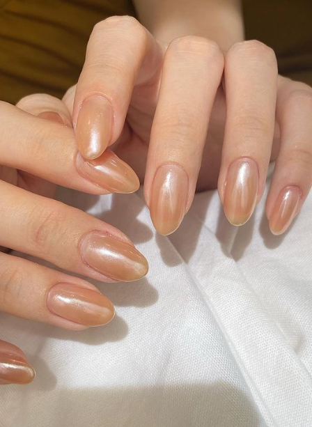 nude nails warm skin tone. shimmer nude nails inspo. nude nail ideas simple. nude nail trends.