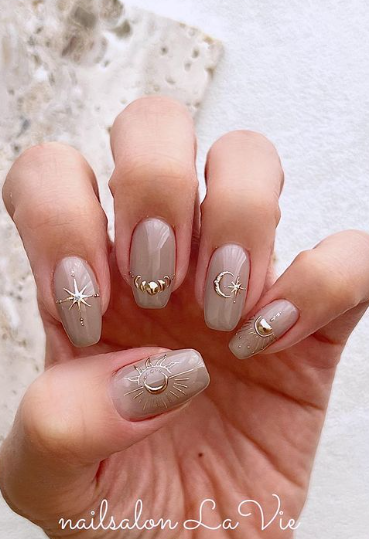 warm nude nails with gold nail art.