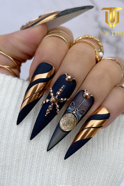 navy blue and gold christmas acrylic pointed nails. winter festive nail ideas.