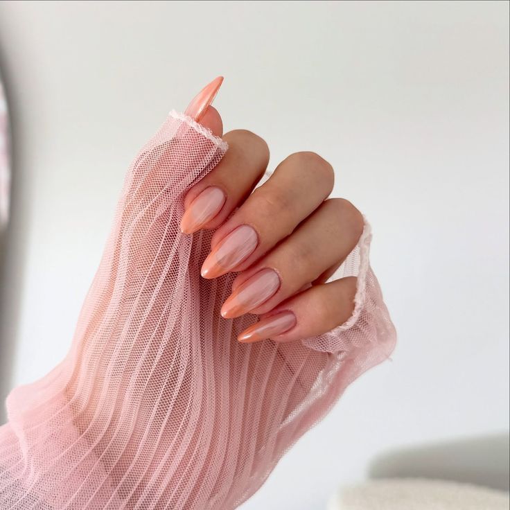 Apricot and rose gold fall almond nails. French tipped peach colored nails in chrome finish. Apricot and rose gold fall almond nails. French tipped peach colored nails in chrome finish.