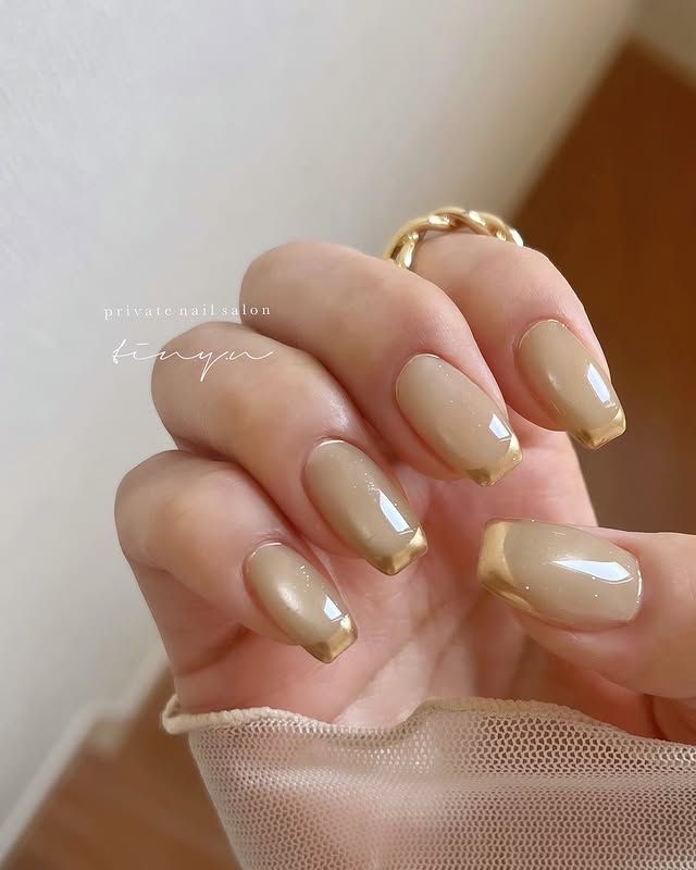 Warm beige nails with gold French tips for fall Warm beige nails with gold French tips for fall