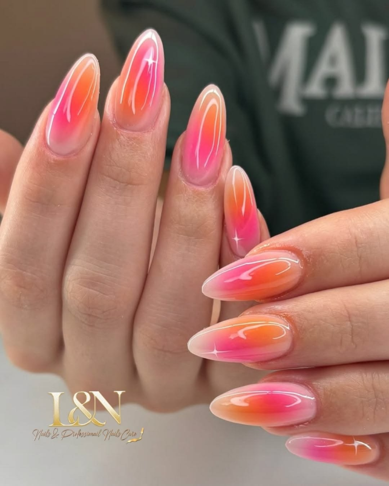 Pink and orange acrylic summer aura nails.