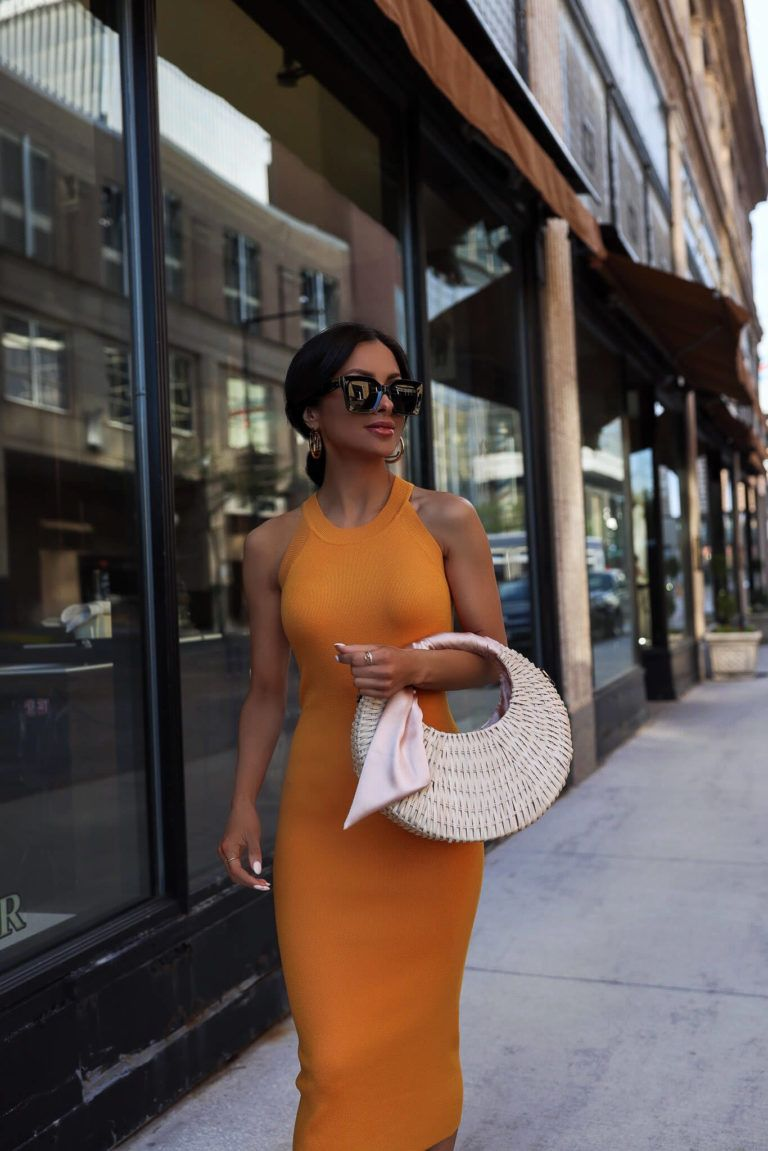 Summer straw handbag with orange summer dress.