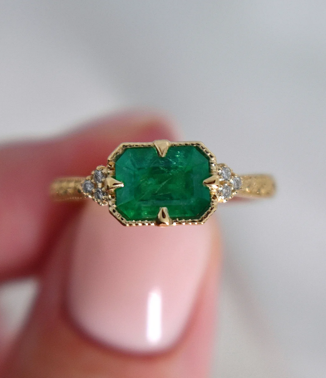 Emerald east west set colored vintage engagement ring in yellow gold