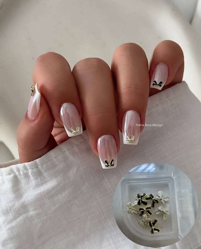 French acrylic nails with bows in chrome finish.