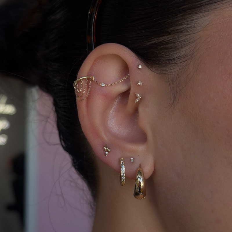 Flat earrings with chains piercing stack. Flat earrings with chains piercing stack.