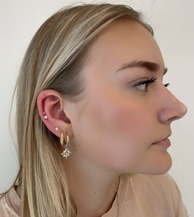 Small studs with large main hoop earrings. Small studs with large main hoop earrings.