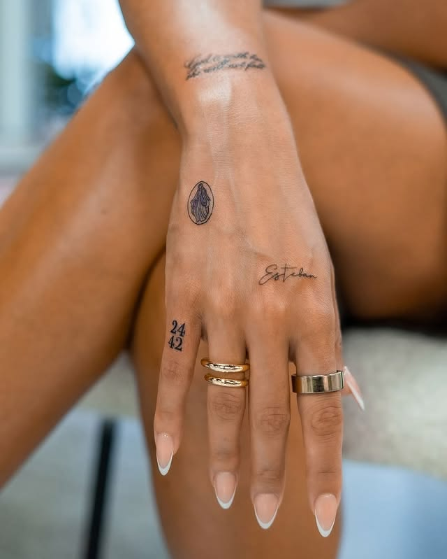 Simple, elegant name hand tattoo.
