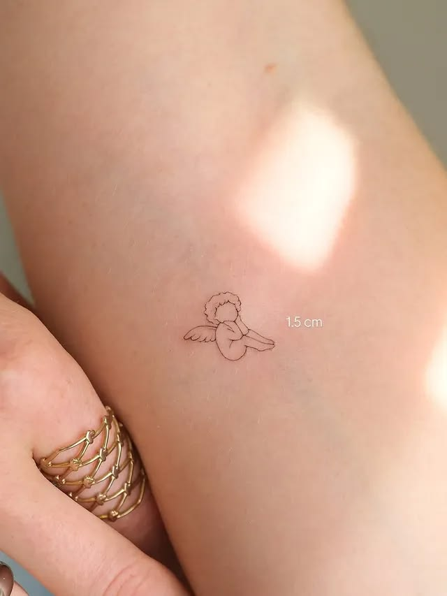 Small cherub angel tattoo for women.