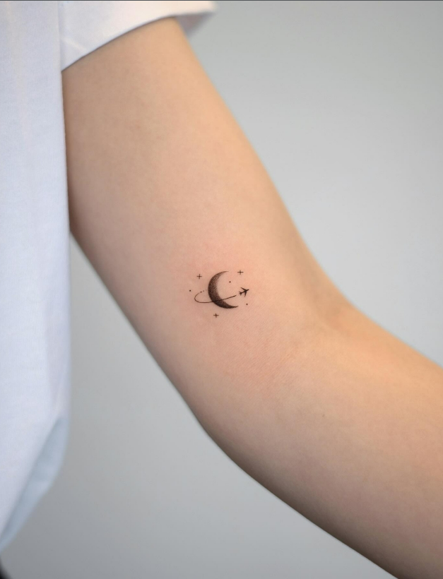 Moon, star and airplane travel tattoo.
