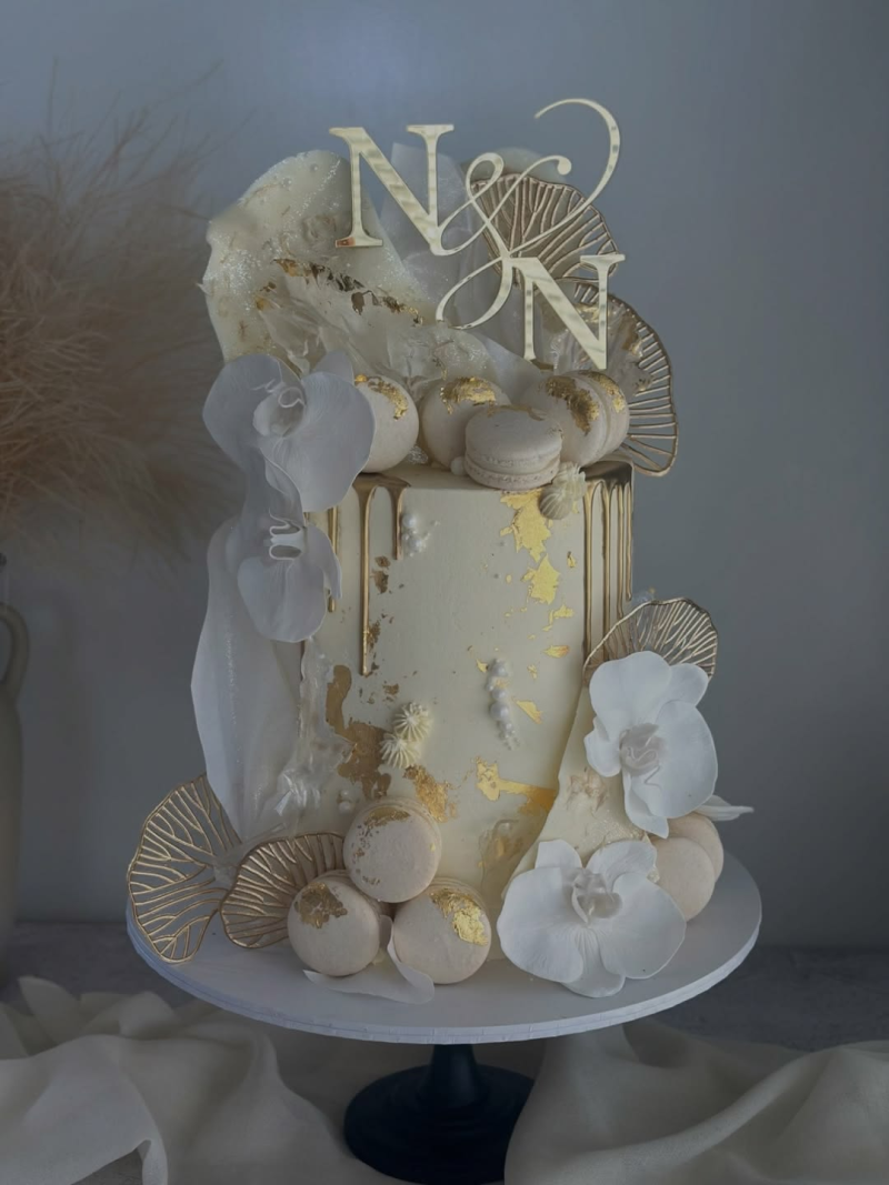 Cream and gold tiered wedding cake with macarons Cream and gold tiered wedding cake with macarons