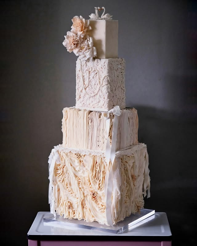 Peach colored lace tiered wedding cake. Peach colored lace tiered wedding cake.