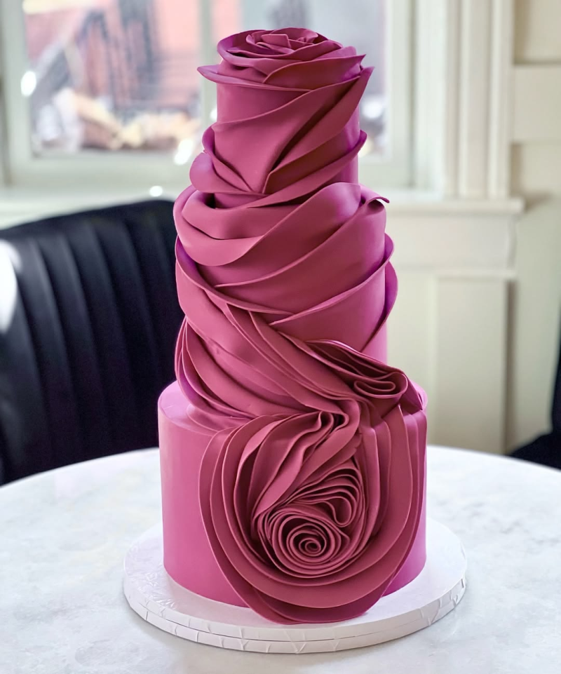 Rose-shaped wedding cake in deep berry pink. Rose-shaped wedding cake in deep berry pink.