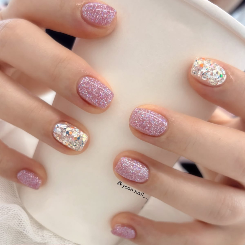 Pink and gold glitter short nails for party or holidays.