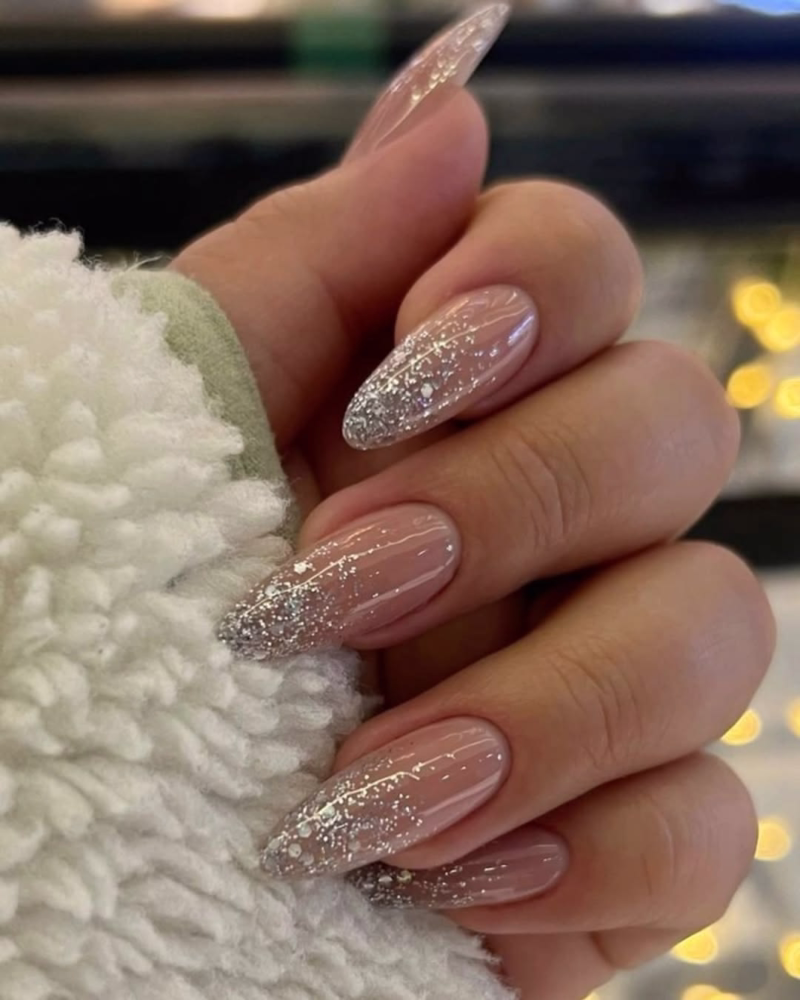 Silver glitter nail tips on nude almond classy nails. Engagement nails and wedding nails.